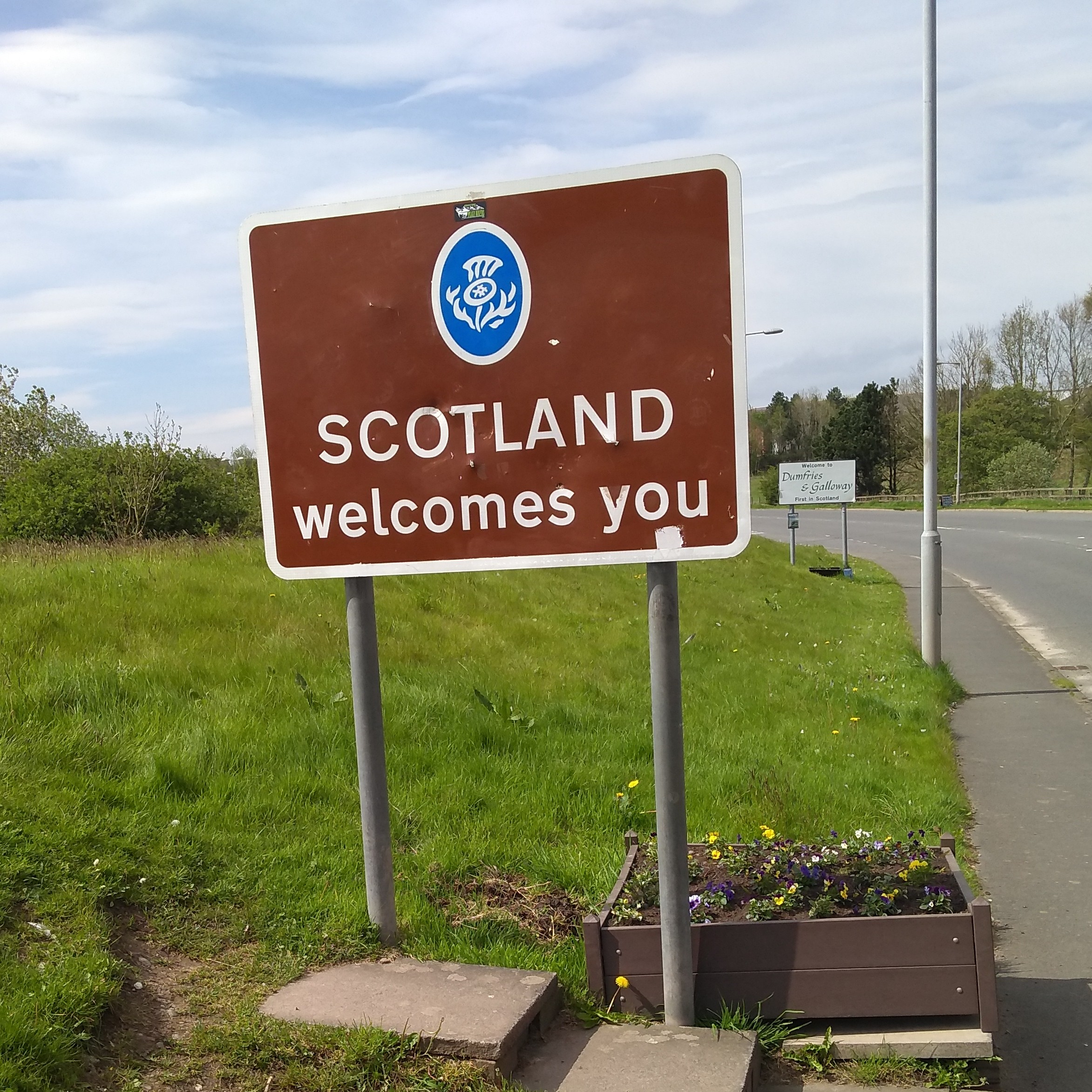 "Scotland welcomes you" sign